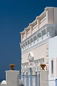 Greece, Santorini, Thira, Oia. Ornate pink villa facade against clear blue sky