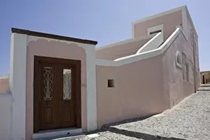 Images Dated 10th June 2005: Greece, Santorini, Thira, Oia. Pink villa with wooden door