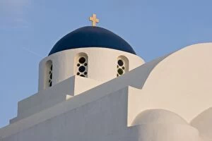 Greece, Santorini. White church with blue dome against blue sky