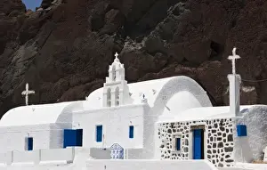 Stark Prints: Greece, Santorini. White Greek Orthodox church starkly contrasts with red cliff
