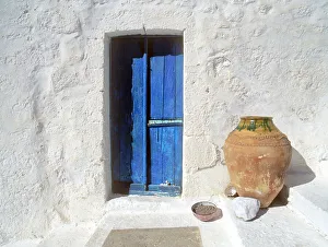 Jim Nilsen Prints: Greece, Symi. Blue door and pot. Credit as: Jim Nilsen / Jaynes Gallery / DanitaDelimont