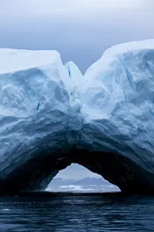 Arched Prints: Greenland, Ilulissat, Arch formed within melting iceberg grounded near face of Jakobshavn