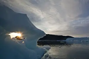 Images Dated 13th June 2010: Greenland, Ilulissat, Setting midnight sun lights iceberg floating near Eqip Glacier