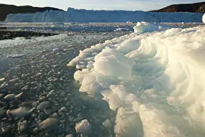 Images Dated 13th June 2010: Greenland, Ilulissat, Setting midnight sun lights icebergs floating at face of Eqip