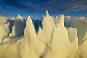 Images Dated 13th June 2010: Greenland, Ilulissat, Setting midnight sun lights jagged floating iceberg near Eqip