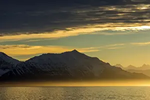 Inger Hogstrom Prints: Greenland. Kong Oscar Fjord. Sunset over the calm water of the fjord