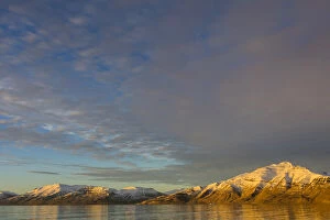 Greenland. Kong Oscar Fjord. Sunset light on the snowy mountains