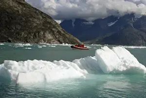 Greenland, Qooroq Fjord. A rubber raft navigates through a sea of icebergs on Qooroq