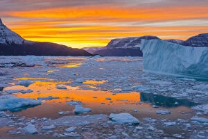 Greenland, Scoresby Sund, Gasefjord. Sunset with icebergs and brash ice