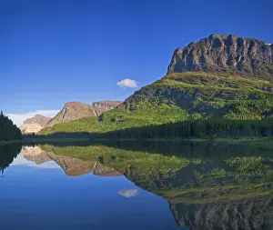 Images Dated 21st July 2010: Grinnel Point and Allen Mountain reflect into Fishercap Lake in the Many Glacier