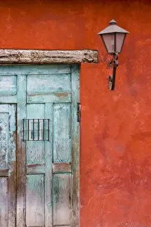 Sacatepequez Department Prints: Guatemala, Antigua. Aqua blue door against colorful red wall in Antigua