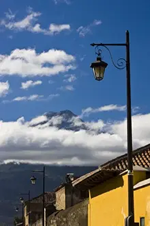 Lamp Post Prints: Guatemala, Antigua. Lamp post with Volcano Agua in background covered with clouds