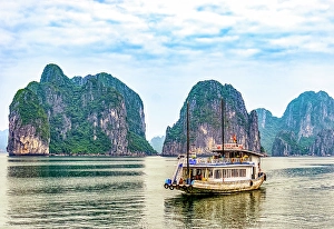 Turquoise Prints: Ha Long Bay, Vietnam. Landscape view of tourist boat cruising among limestone karsts and islets in famous UNESCO Site