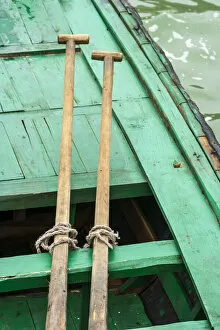 Ha Long Bay, Vietnam (UNESCO World Heritage Site). Close-up of oars on a green boat