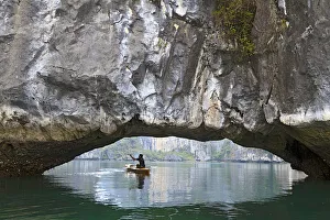 Kayak Prints: Ha Long Bay, Vietnam. View of kayaker through limestone arch