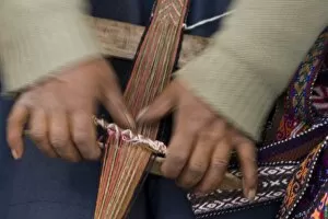 Hands weaving on traditional foot loom, Cuzco, Peru