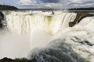 Images Dated 8th September 2015: The headwater of Iguazu Falls with a rainbow from the Argentinian side with Brazil in the background