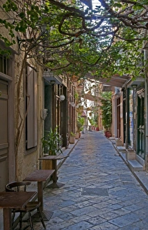 Hermoupolis, Syros Island, Greece. Overhanging plants on quaint downtown street