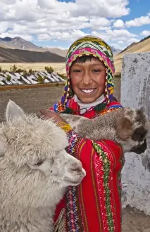 Images Dated 2028 November: High peak at 13, 000 feet of La Raya Peru with young boy with llama portrait (MR)