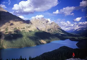Hiker in red jacket overlooking Peyto Lake, Banff National Park, Canada