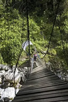 Trekking Prints: Hikers are crossing river Mobuku with the help of the old Kurt Shafer Bridge