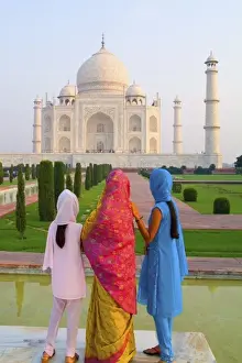 Hindu women with colorful veils in the quiet peaceful Taj Mahal one of the wonders