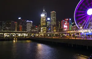 Ferris Wheel Prints: Hong Kong China night skyline with new Ferris Wheel and twilight in city at harbour