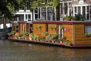 A houseboat docked on the Prinsengracht Canal in Amsterdam, Netherlands