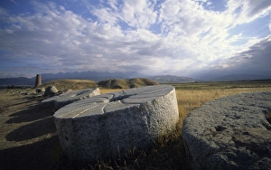 Images Dated 25th June 2007: Huge ancient grinding wheels and Burana Tower, Kirghizstan, Central Asia