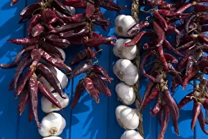 Images Dated 12th September 2009: Hungary, Kalocsa. Fresh garlic and local sweet paprika hanging on blue door