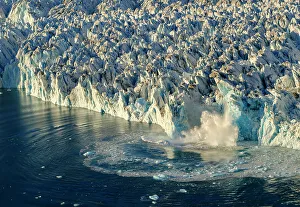 Ice calving. Knud Rasmussen Glacier (also called Apuseeq Glacier) in Sermiligaaq Fjord, Ammassalik, Danish Territory