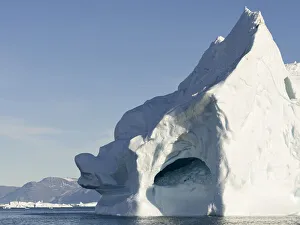 Iceberg in the Uummannaq Fjord System. Glaciated Nuussuaq peninsula in the background