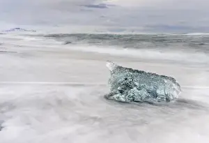 icebergs on black volcanic beach. Beach of the north atlantic near the glacial lagoon Joekulsarlon