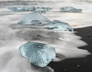 Icebergs on black volcanic beach near the Jokulsarlon glacial lagoon and Breithamerkurjokull