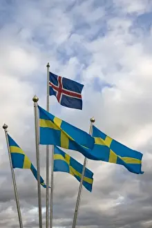 Flag Pole Prints: Iceland. The national flag of Norway flies above a grouping of Swedens National flags