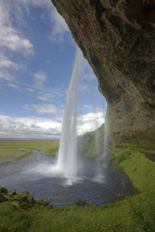 Iceland, Selfoss. Scenic from behind the Seljalandsfoss waterfall. Credit as: Josh