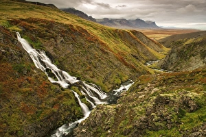Images Dated 24th September 2013: Iceland, Snaefellsnes Peninsula. Small waterfall and fall colors on landscape. Credit as