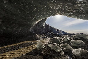 Icelandic Prints: Iceland. Sunburst at ice cave entrance
