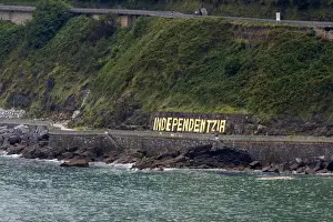 Liberian Peninsula Prints: Independentzia painted on a rock wall by Basque separatists across the harbor from Ondarroa