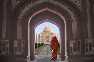 Prints of India, Agra, Taj Mahal. Composite of woman in archway facing mausoleum Asia Prints: India, Agra, Taj Mahal. Composite of woman in archway facing mausoleum