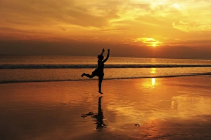 Images Dated 5th December 2013: India, Andaman Islands, Havelock, beach number 7, shadow of woman jumping at sunset