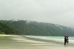 India, Andaman Islands, Havelock, Indian tourist below umbrella on beach number 7