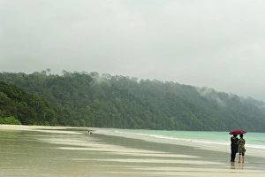 India, Andaman Islands, Havelock, Indian tourist below umbrella on beach number 7 India, Andaman Islands, Havelock, Indian tourist below umbrella on beach number 7