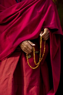 Robe Prints: India, Jammu & Kashmir, Ladakh, Leh, capital of Ladakh hands of a monk in red holding