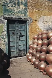 Closed Prints: India, Rajasthan, Ceramic pot shop with iron doorway in background