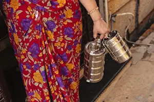 Images Dated 31st October 2011: India, Rajasthan, Jaisalmer. Woman in traditional dress holding lunch boxes