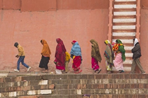 Ganges Prints: India, Uttar Pradesh, Varanasi. women and child walk along the Ganges river bulkhead