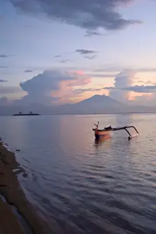 Outrigger Prints: Indonesia, Bali. Sunrise on fishing boat and Sanur Beach with Mount Gunung Agung in distance