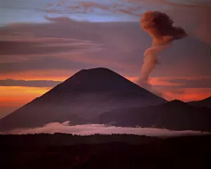 Images Dated 13th August 2007: Indonesia. Mt. Semeru emits a plume of smoke moved by strong winds at sunrise. Credit as