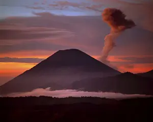 Erupt Prints: Indonesia. Mt. Semeru emits a plume of smoke moved by strong winds at sunrise. Credit as